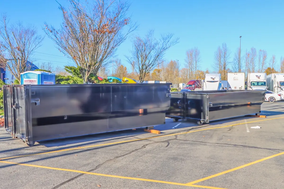 Professional dumpster rental service with roll-off container on residential driveway in North Fair Oaks